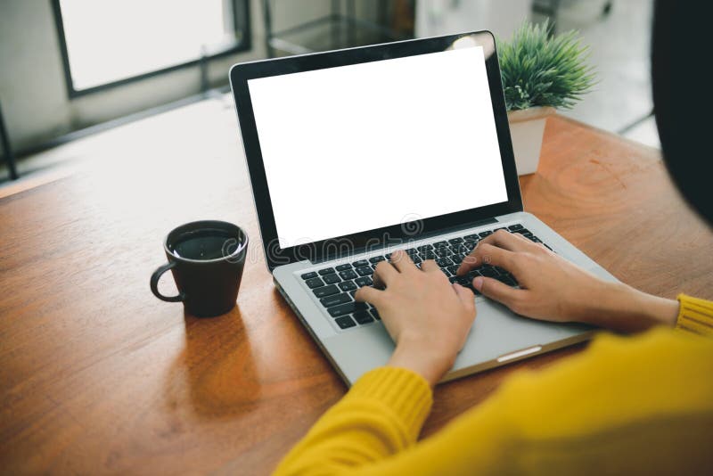 Digital lifestyle working outside office. Woman hands typing laptop computer with blank screen on table in coffee shop.