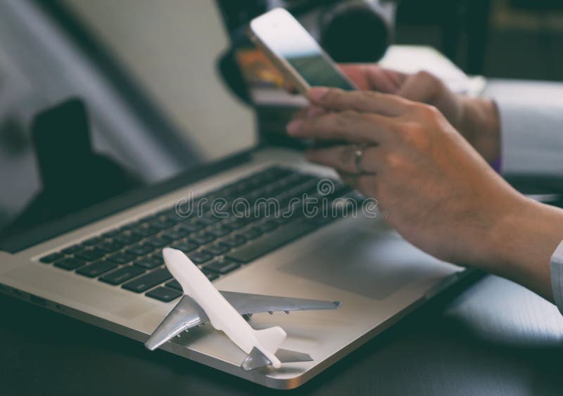 Business traveler using his phone to book his trip