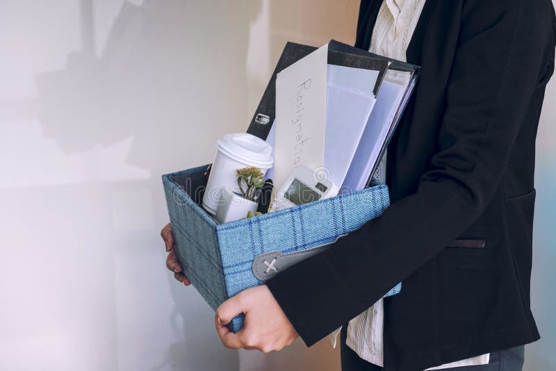 Business woman carrying packing up all his personal belongings a stock photography Business woman carrying packing up all his personal belongings a stock photography