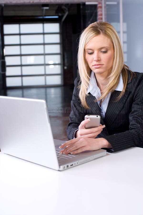 Business Woman on cell at desk