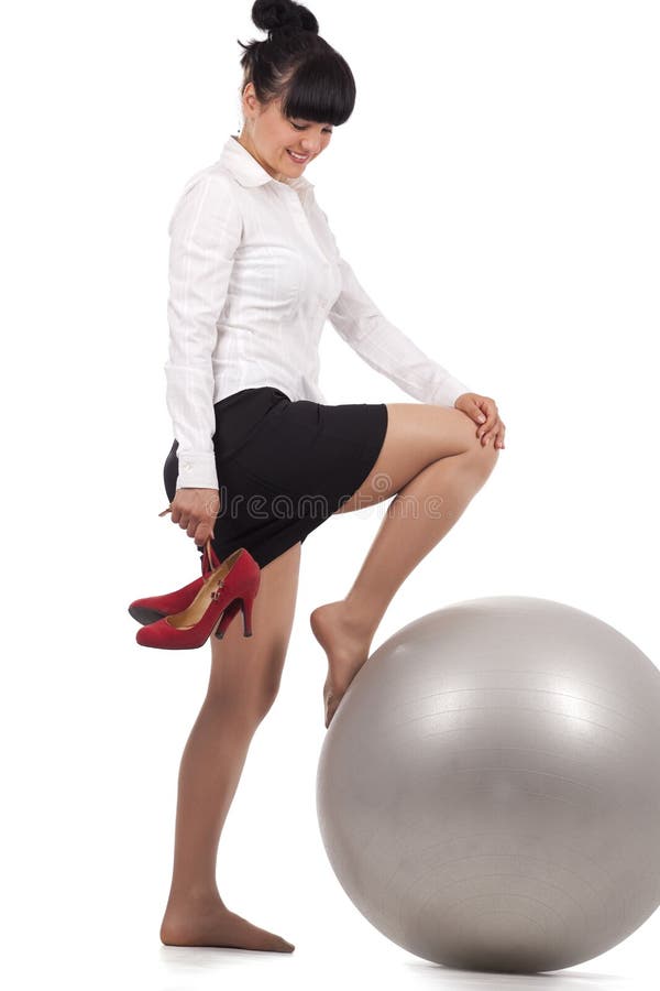 Business woman doing exercise with workout ball