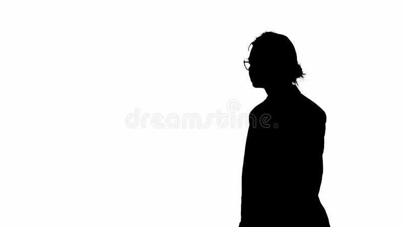 Business woman in formal outfit walking. Half-turn. Black silhouette on a white isolated background.