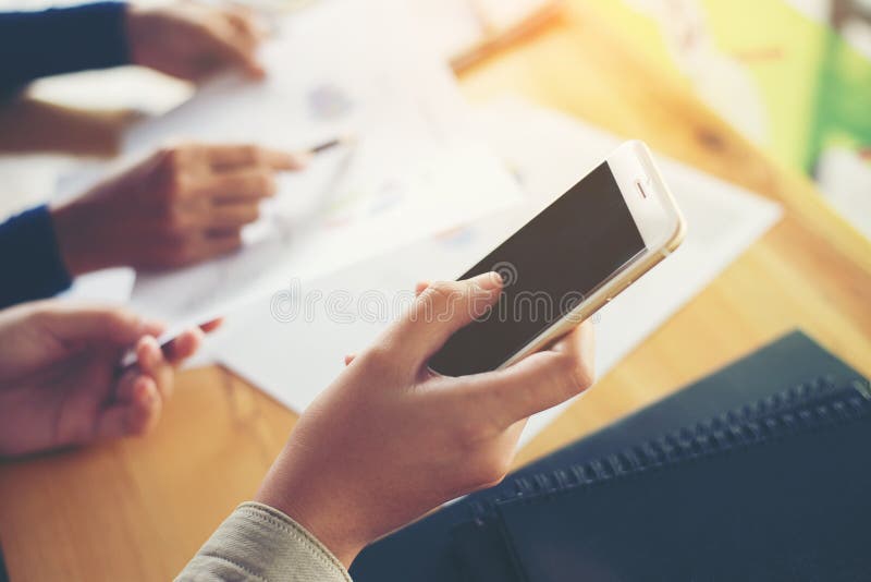 Business woman hand working on smart phone with business graph