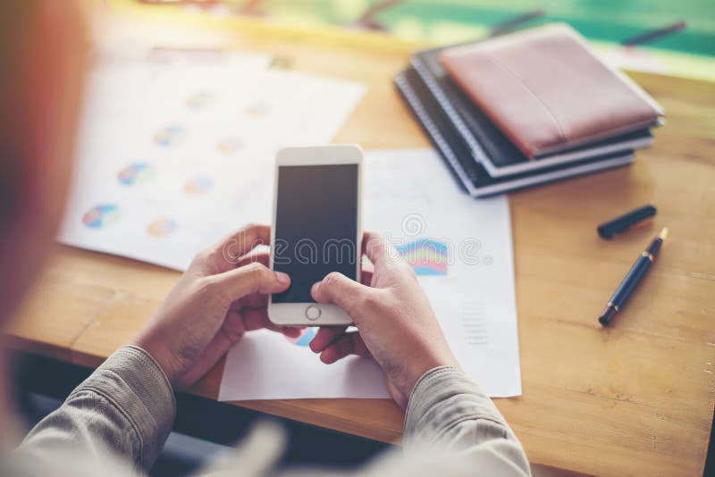 Business woman hand working on smart phone with business graph