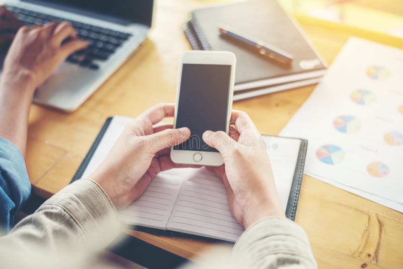 Business woman hand working on smart phone with business graph