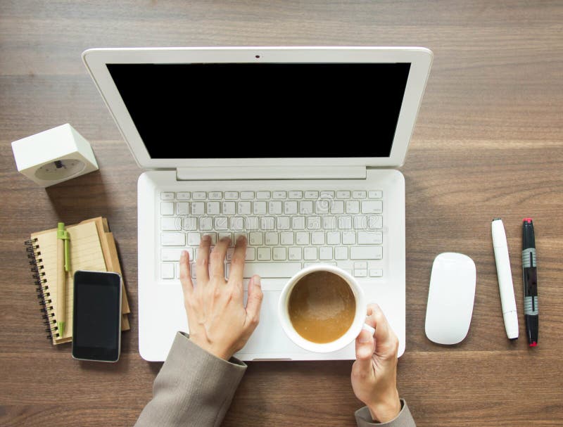 Business Woman Having A Coffee Break While Working At His Office Desk, Top View With Laptop Computer On Wooden Table