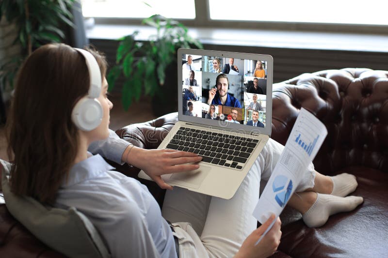 Business woman in headphones lying on sofa speak talking to her colleagues royalty free stock images Business woman in headphones lying on sofa speak talking to her colleagues royalty free stock images