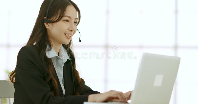 Business woman in headphones with microphone consulting client on phone in customer support service