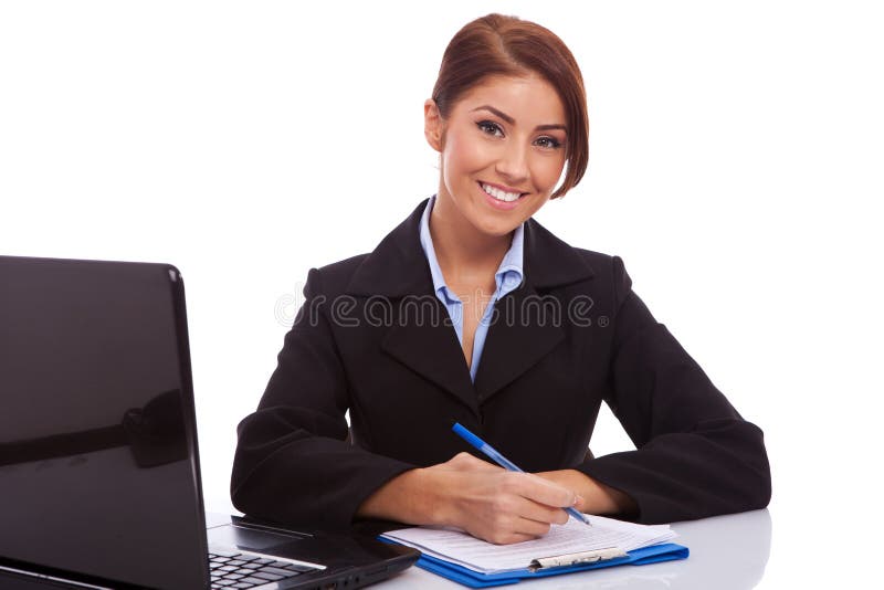 Business woman at her desk writing