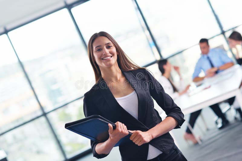 Business woman with her staff in background at office royalty free stock images Business woman with her staff in background at office royalty free stock images