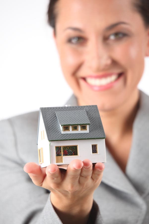 Business woman holds model of house