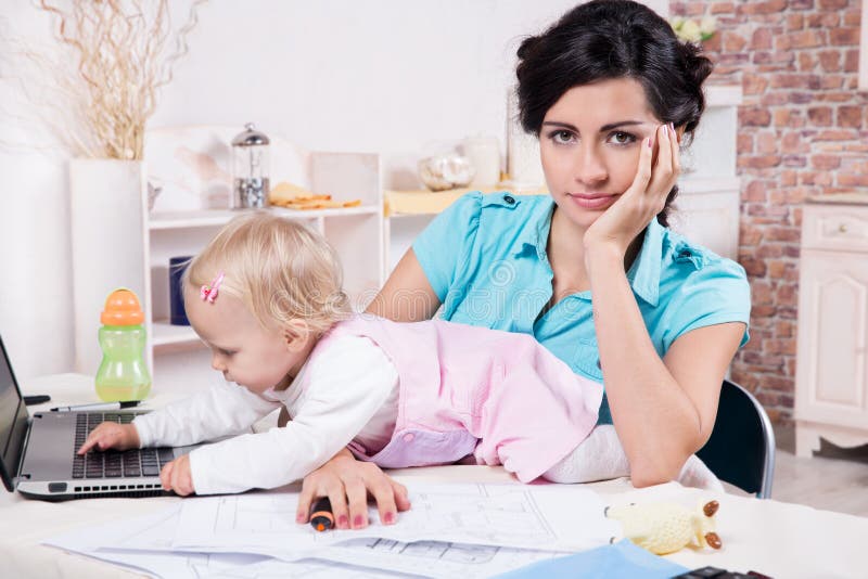 Business woman with laptop and her baby girl