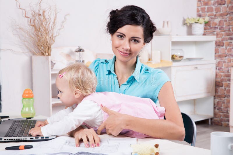 Business woman with laptop and her baby girl