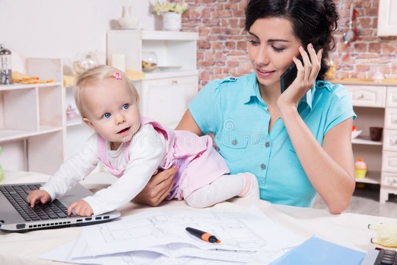 Business woman with laptop and her baby girl