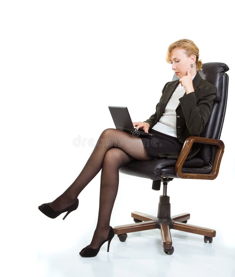 Business woman with laptop sitting in a chair