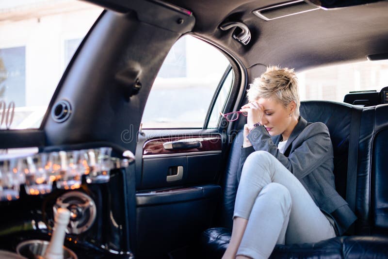 Business woman at limo having stressful day