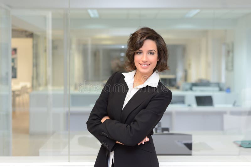 Business woman in a office. Crossed arms