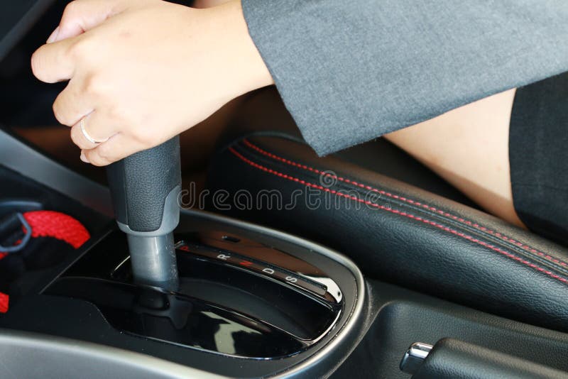 Woman Driver Shifting The Gear Stick And Driving A Car In The Road