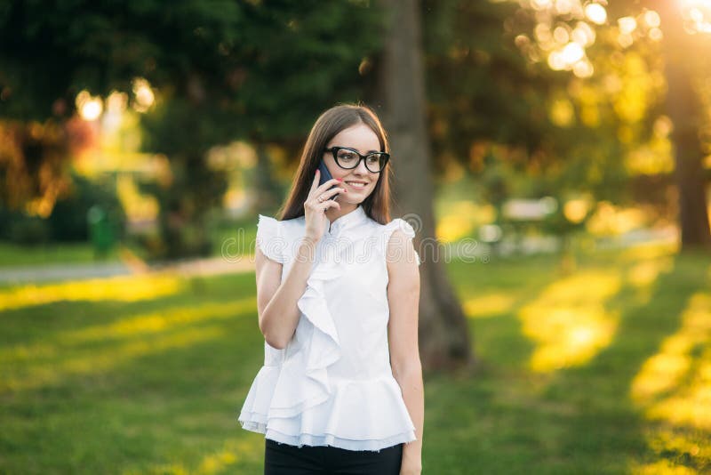 Business woman in the park using phone royalty free stock image Business woman in the park using phone royalty free stock image