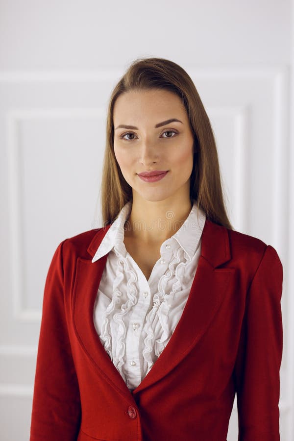 Business Woman in Red Standing at Modern Office. Headshot of a Young ...