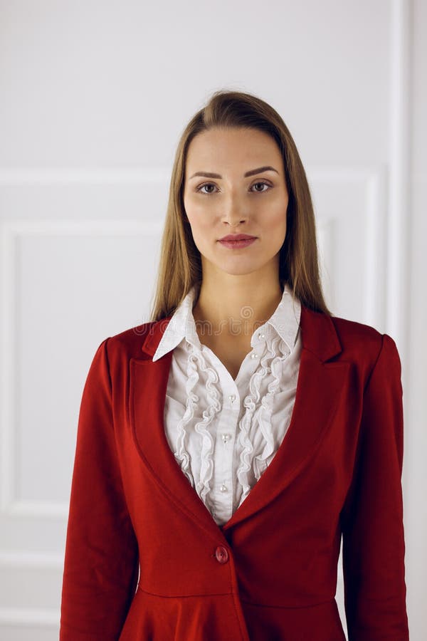 Business Woman in Red Standing at Modern Office. Headshot of a Young ...