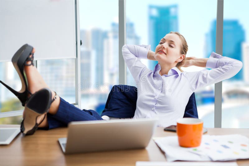 business woman relaxing or sleeping with her feet on the desk in office. female boss worker close eyes sitting with legs on the table in the resting time at work place on city background