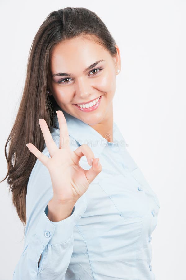 Business woman showing OK hand sign smiling happy