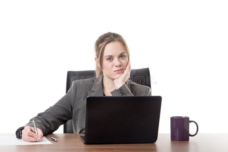 Young business woman sitting a her desk royalty free stock image Young business woman sitting a her desk royalty free stock image