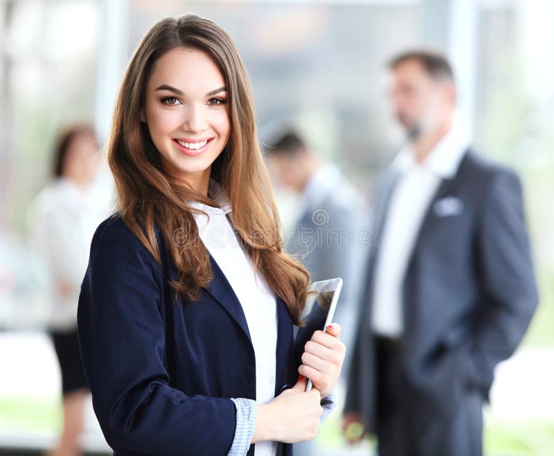 Business woman standing in foreground with a tablet in her hands stock images Business woman standing in foreground with a tablet in her hands stock images