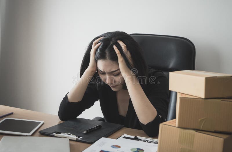 Business woman stressed out with work on office desk stock image Business woman stressed out with work on office desk stock image