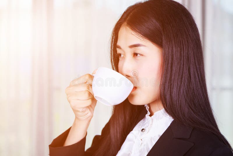 Business woman in suit drinking coffee or tea cup stock images Business woman in suit drinking coffee or tea cup stock images