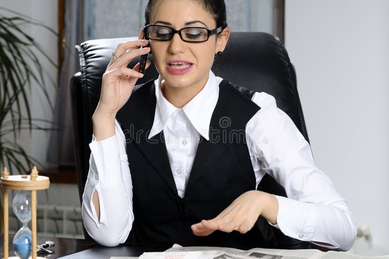 business woman arguing on cell phone in office. business woman arguing on cell phone in office