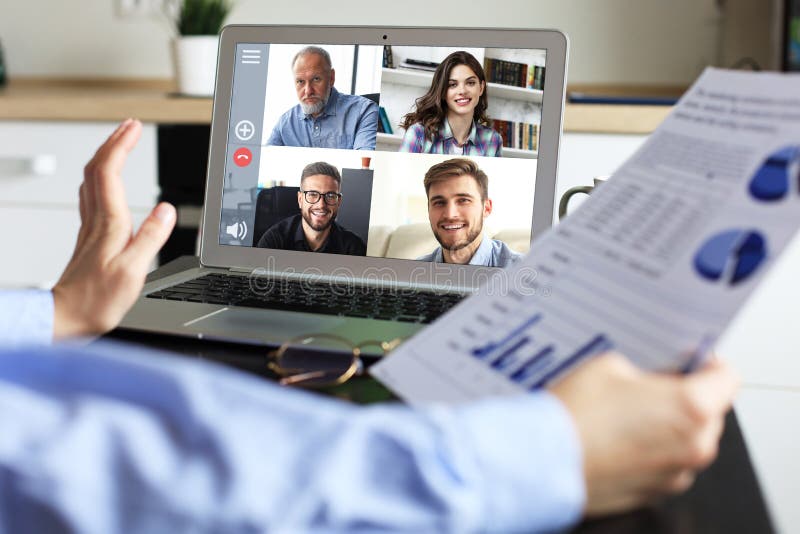 Business woman talking to her colleagues in video conference. Business team working from home using laptop stock photography