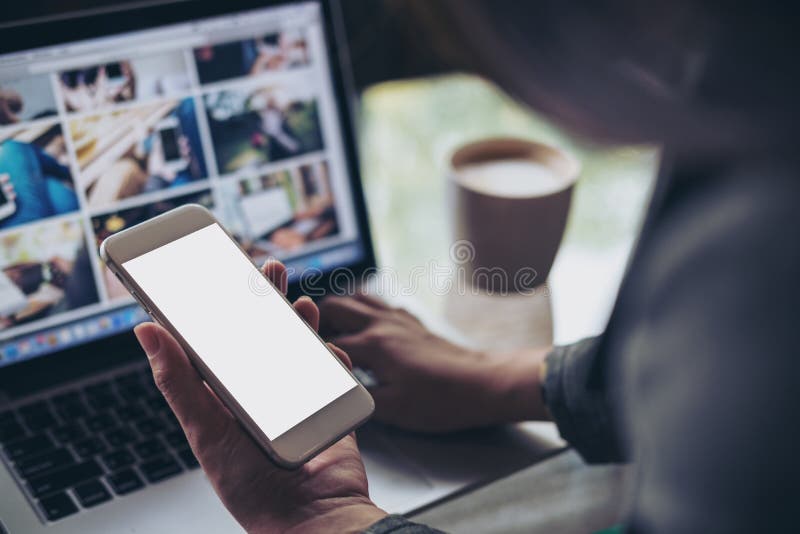 Business woman using mock up smart phone with laptop royalty free stock photo Business woman using mock up smart phone with laptop royalty free stock photo