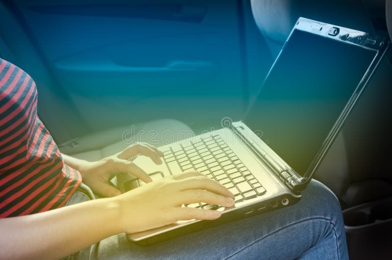 Business woman with working laptop in a car stock photos Business woman with working laptop in a car stock photos