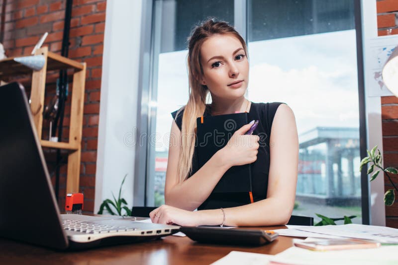 Business woman working at the office looking at camera. royalty free stock photo