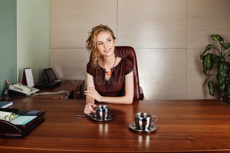 Business woman working at the office and smiling