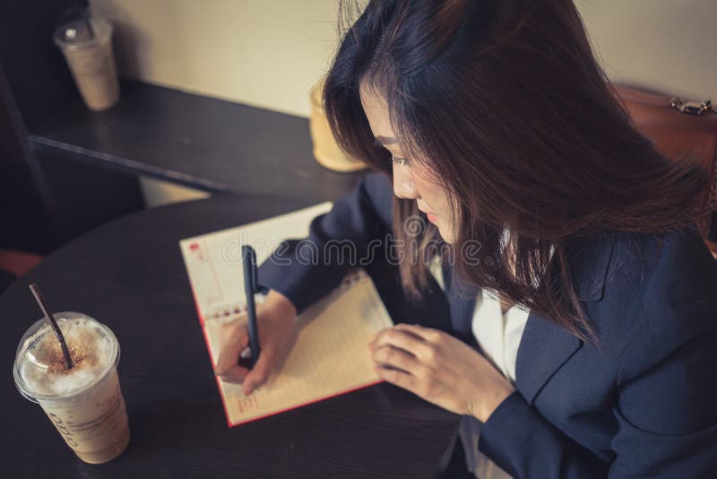 Business women working writing in the cafe stock photo Business women working writing in the cafe stock photo
