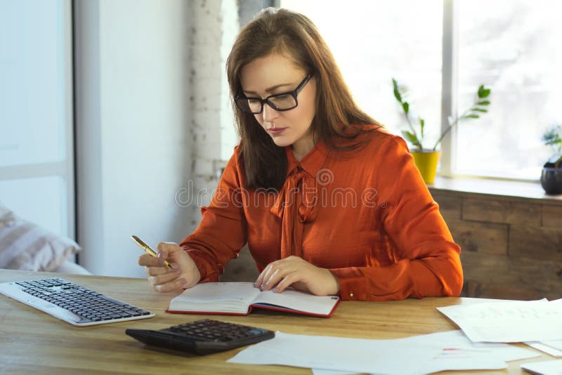 Business woman writing in notebook.