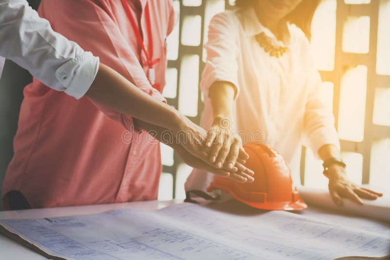 Business women and engineer working hands of business people joined hands together in office meeting. Teamwork Concept and royalty free stock photos Business women and engineer working hands of business people joined hands together in office meeting. Teamwork Concept and royalty free stock photos