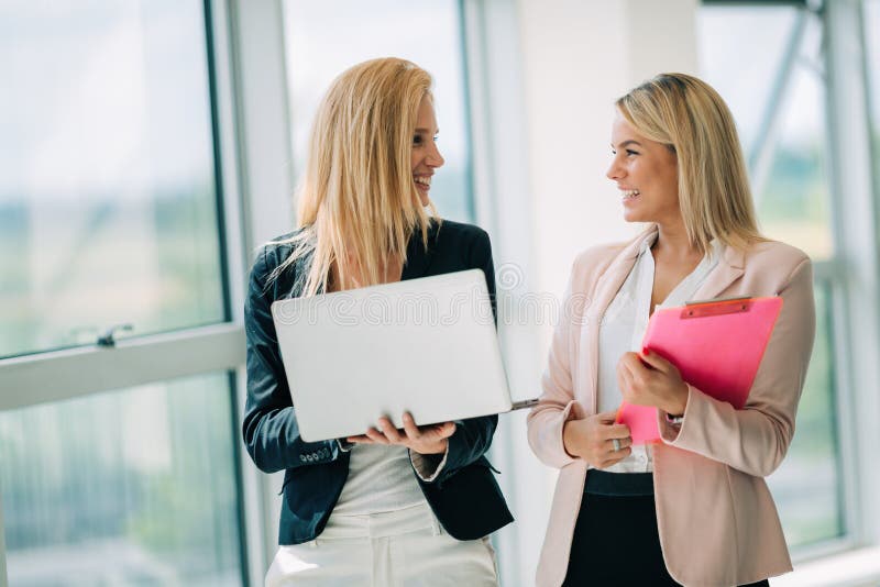 Business women look and smile conversation with digital tablet in office stock image Business women look and smile conversation with digital tablet in office stock image