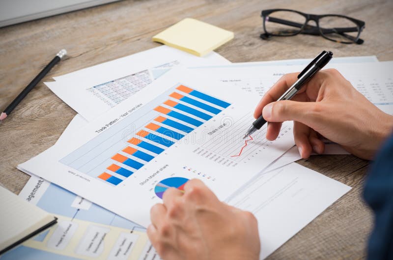 Businessman analyzing graphs stock images Businessman analyzing graphs stock images