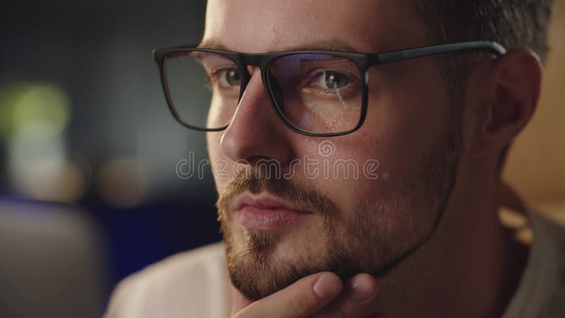 Businessman analyzing stock market. Man in glasses looking on the monitor and working with trending graphics in