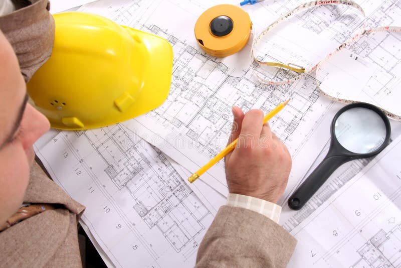 Businessman with architectural plans stock photography