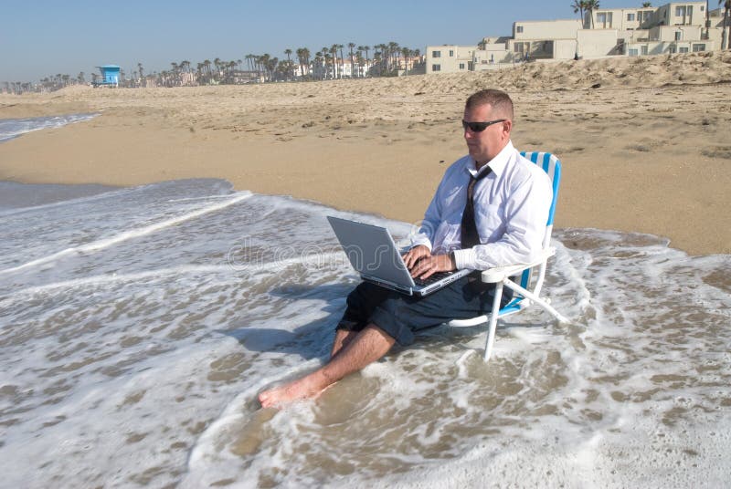 Businessman on beach working