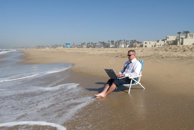 Businessman on beach working