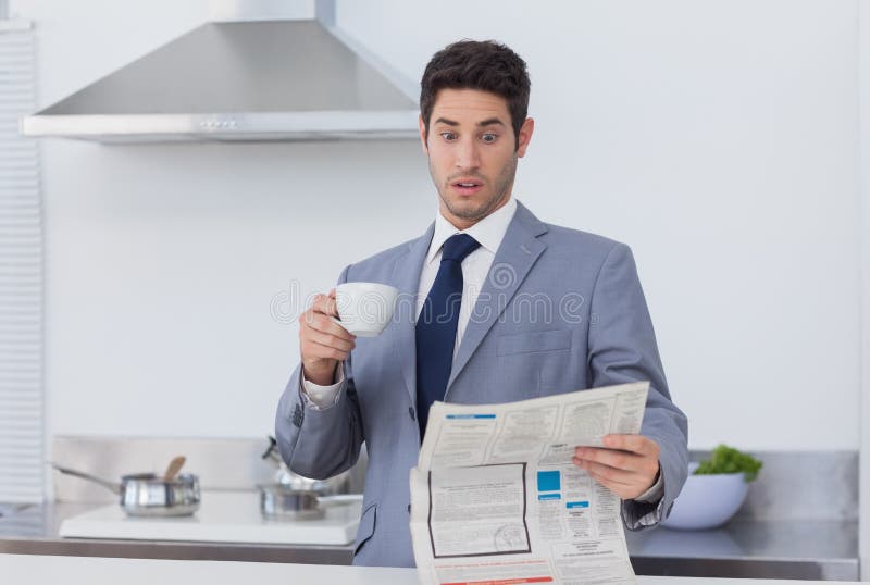 Businessman being astonished when reading the news stock photo Businessman being astonished when reading the news stock photo