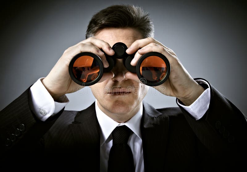 Businessman with binoculars.