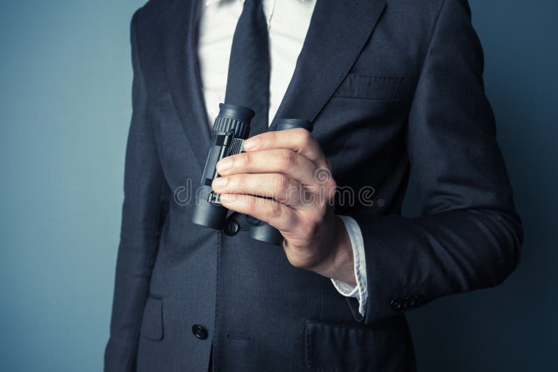 Businessman with binoculars stock image