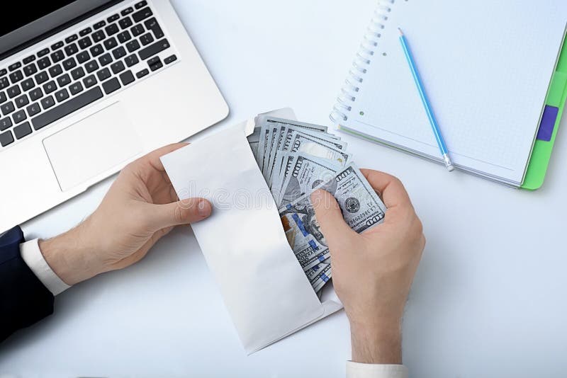 Businessman with bribe at table, royalty free stock images Businessman with bribe at table, royalty free stock images